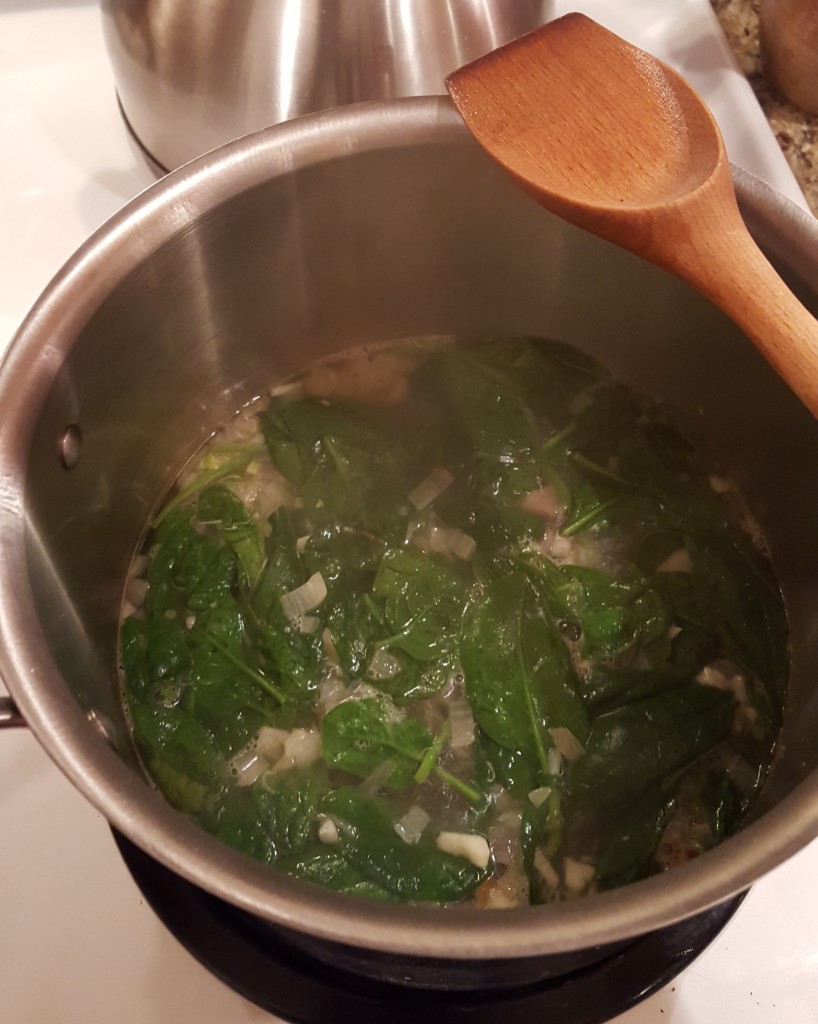 Spinach has been simmered until it wilted. 