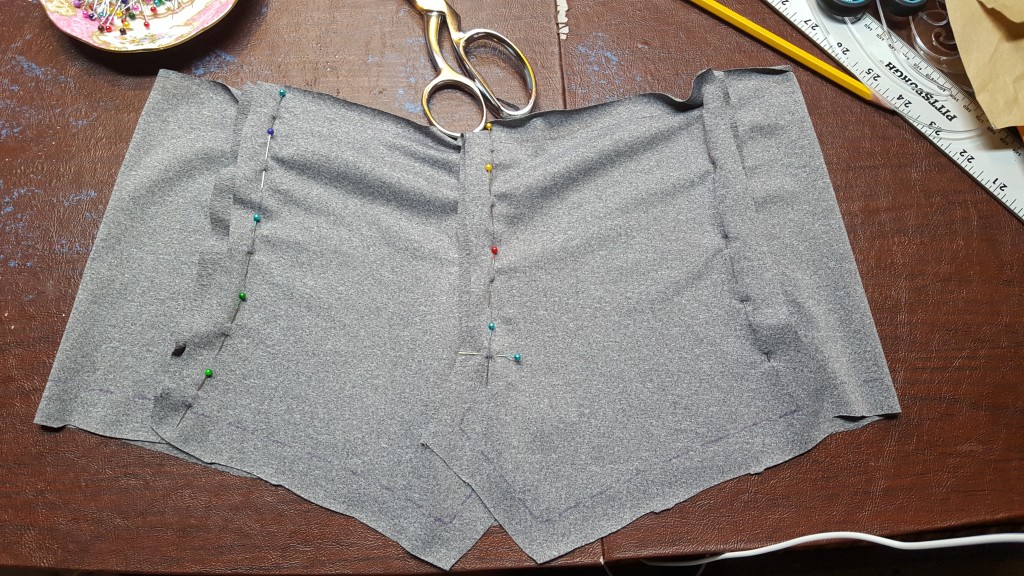 Pin back pieces together up to marking on pattern. Pin back pieces to side fronts. 