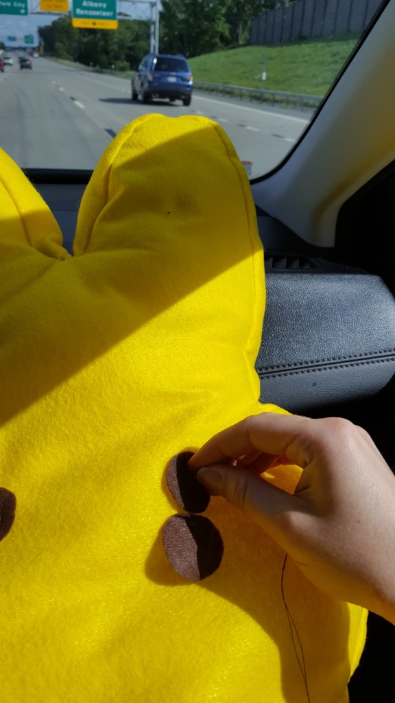 Hand sew the eyes and nose on (preferably while your co-worker drives you home from Ithaca).