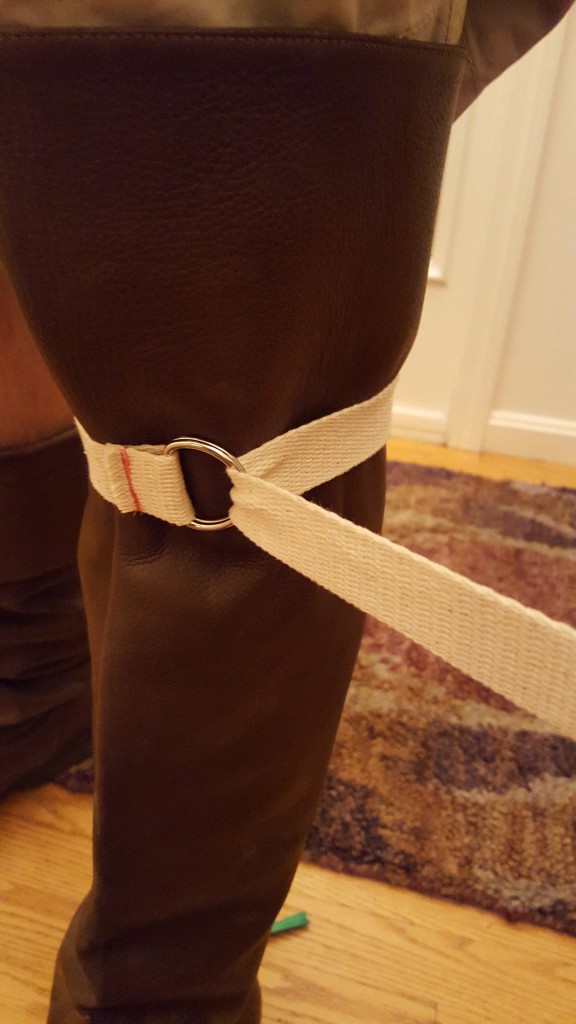 Unfold boot flap and wrap strap around leg.