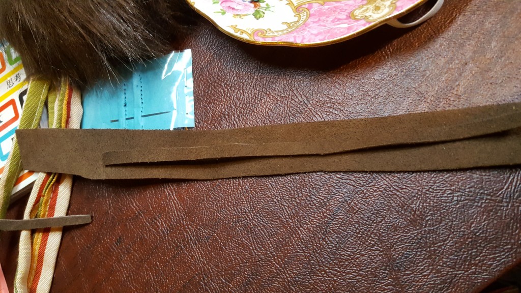 Cut strips of suede for belt