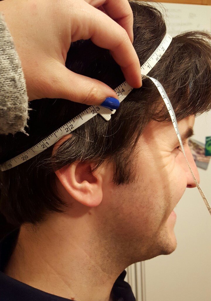 He looks happy to be having his head measured. 