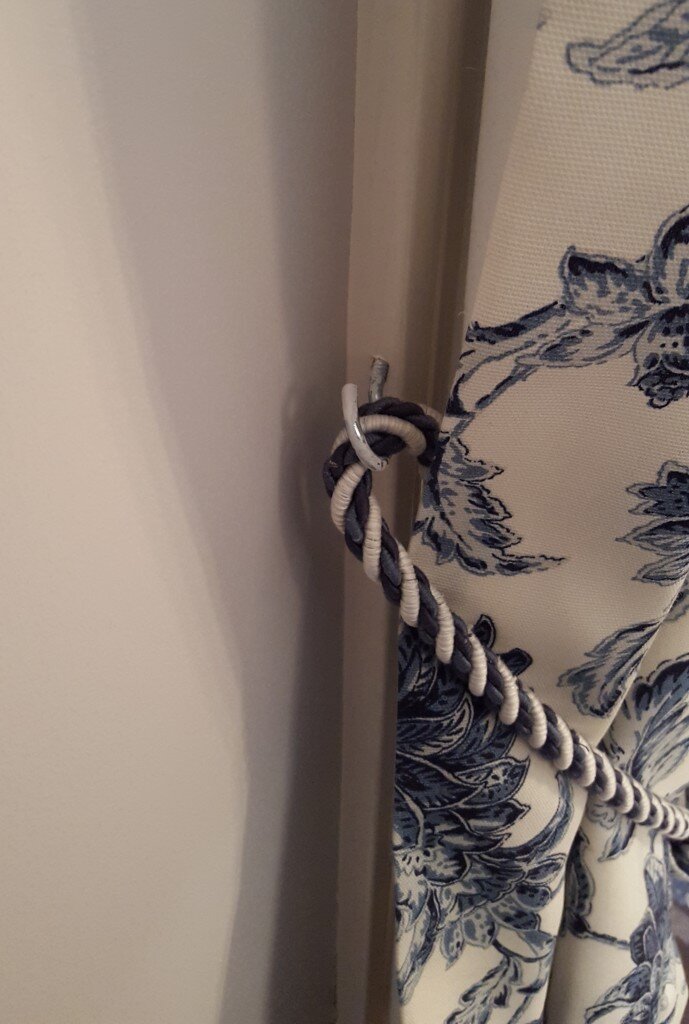 Hidden cup hooks hold the tie backs.