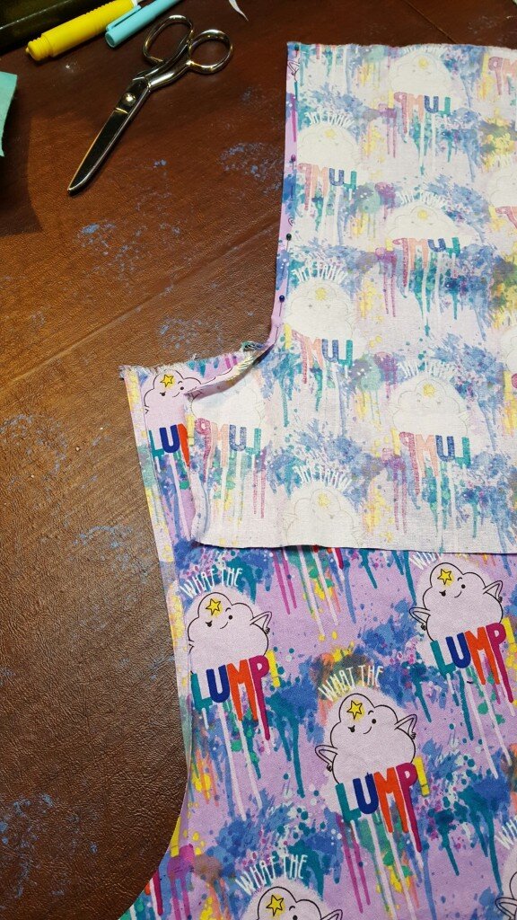 Two pieces to be stitched together, one pressed wrong side out, one pressed right side out.