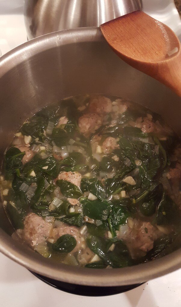 Simmering the soup with the meatballs