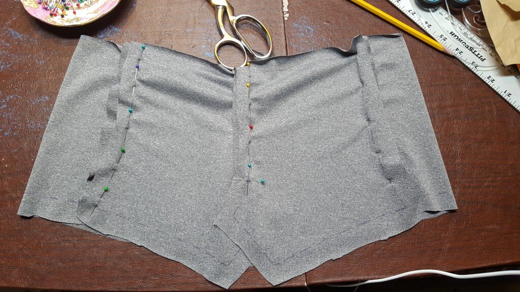 Pin back pieces together up to marking on pattern. Pin back pieces to side fronts. 