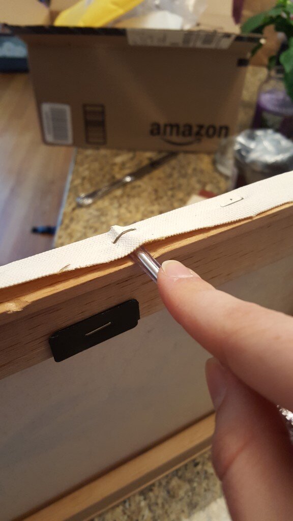 Remove the staples from the canvas