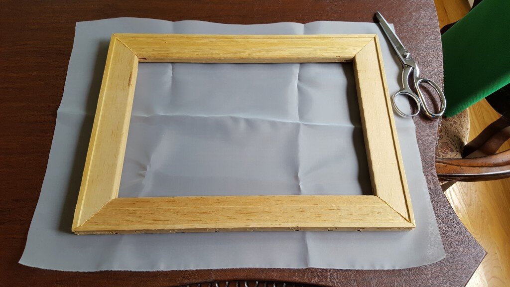 Cut a piece of mesh slightly larger than your frame. 