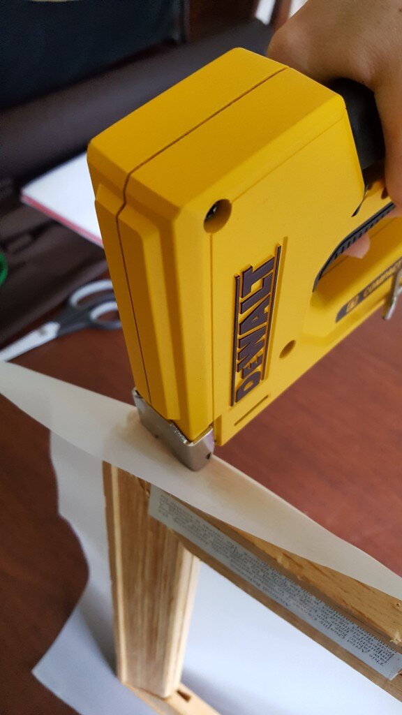 Staple mesh to frame.
