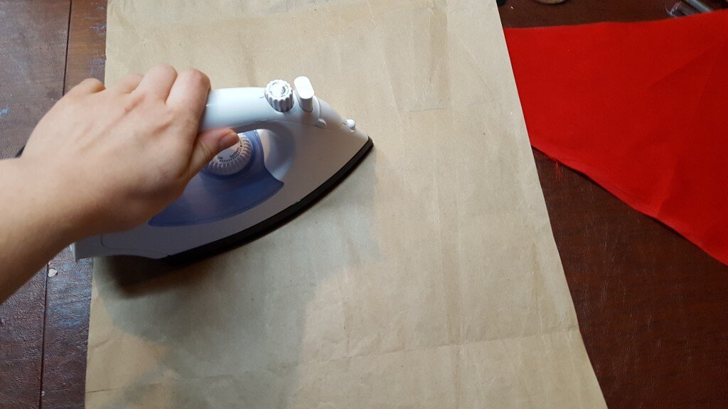 Iron your brown craft paper flat. 