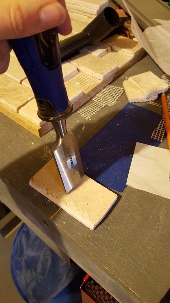 Use chisel to break tile