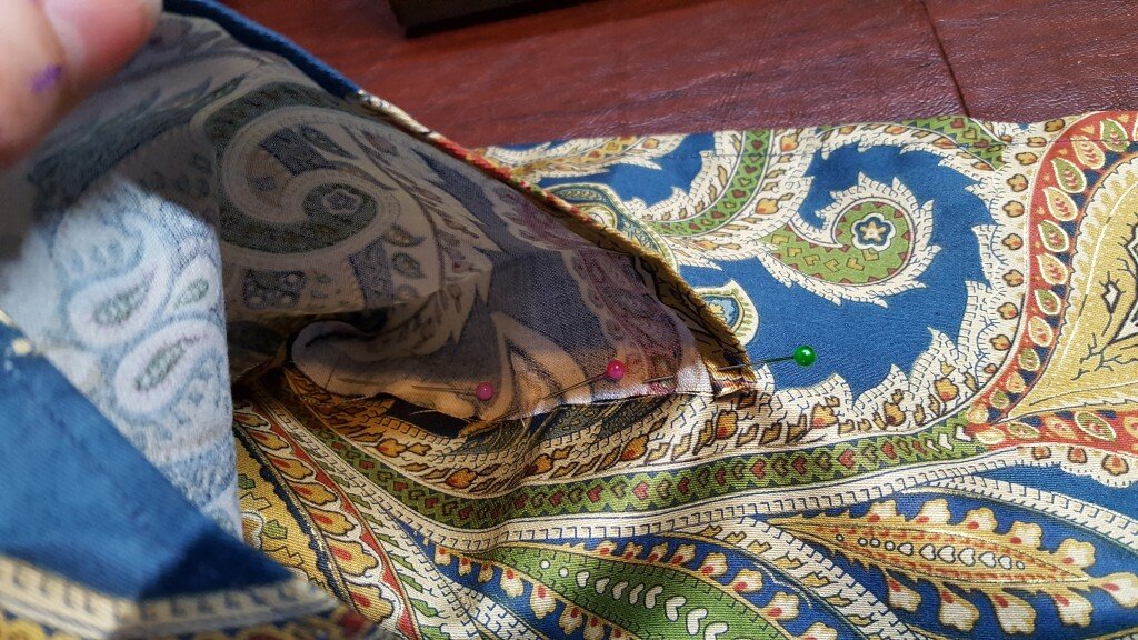 Pin sides of pocket to bag. 