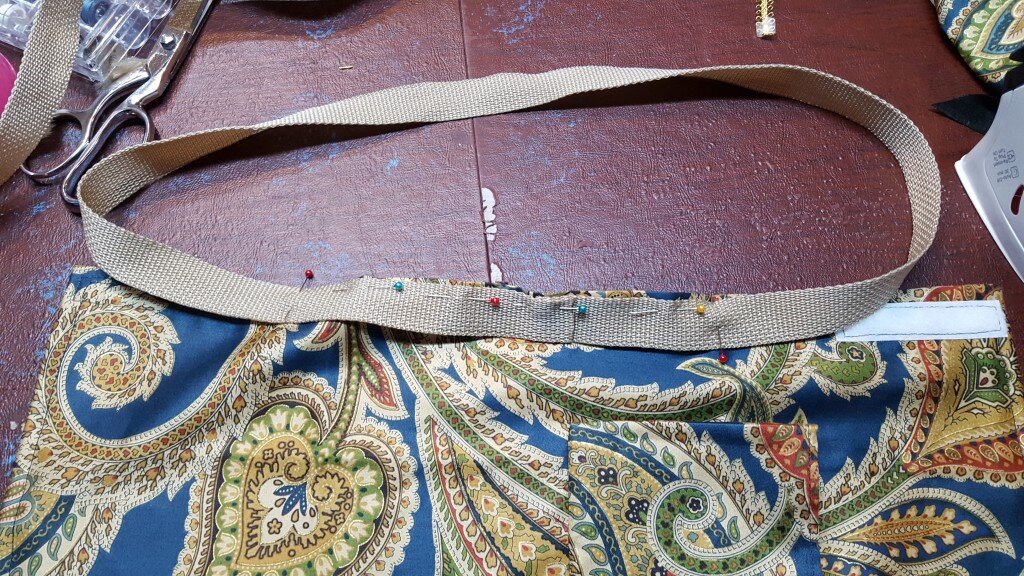 Attach handles to bag. 