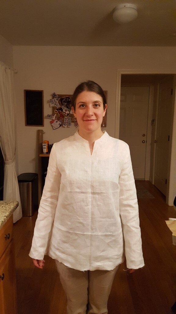 Plain linen tunic without finished collar, sleeves or bottom. 