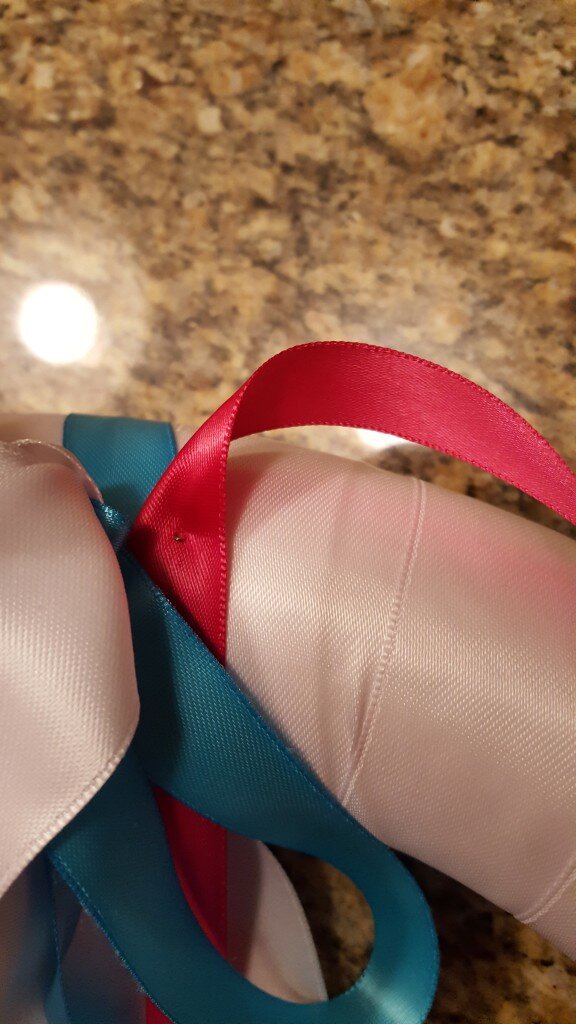 Hang heart underneath bow.