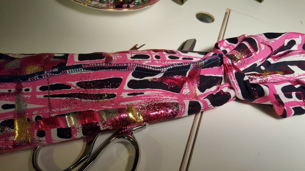 Reach through pocket and pull both ends of tube through the pocket. 