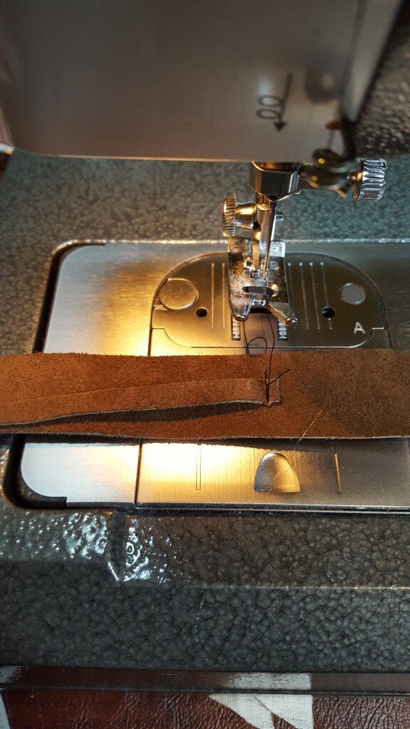 Stitch thin piece of suede to thicker piece of suede in center. 