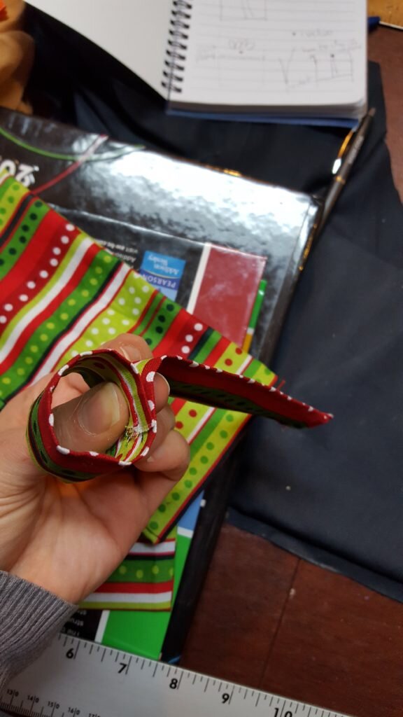 Form a loop to fit around bow and tails, remove from bow. 