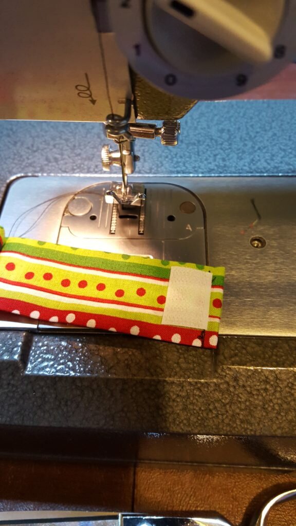 Stitch velcro to end. 