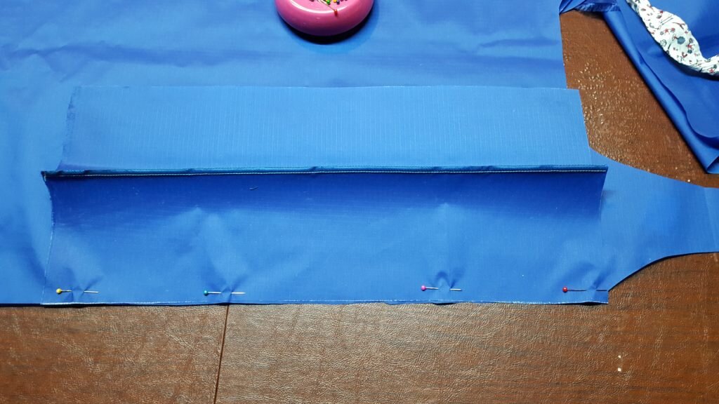 Pin side to body of bag, matching top corner of body to corner of side. 