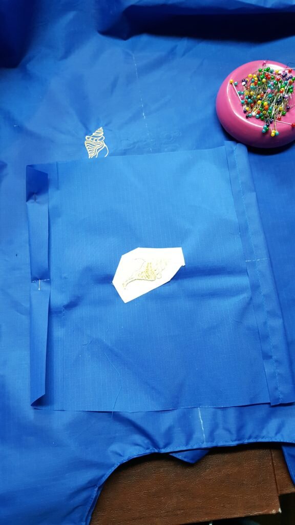 Fold under 1/2" on top of pocket and stitch. 