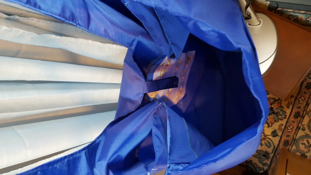 Inside view of the bag. The strips for the snaps just hang inside the bag. 