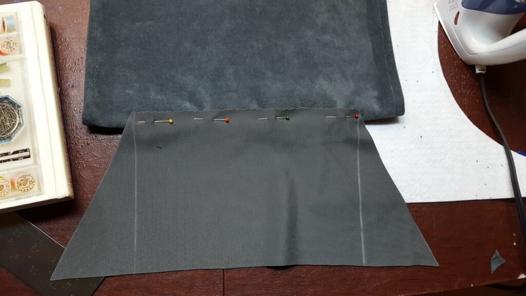 Pin bottom of pocket to bag.