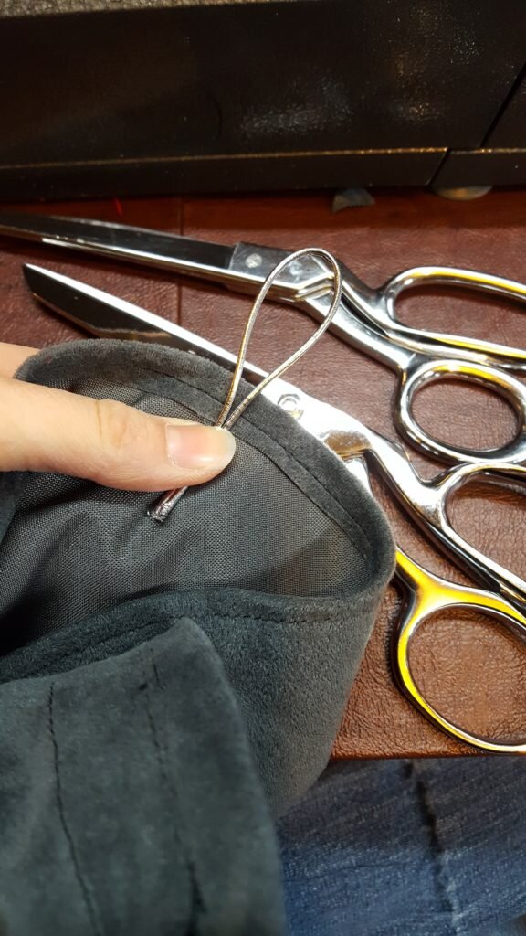 Attach loop of elastic to inside of pocket. 