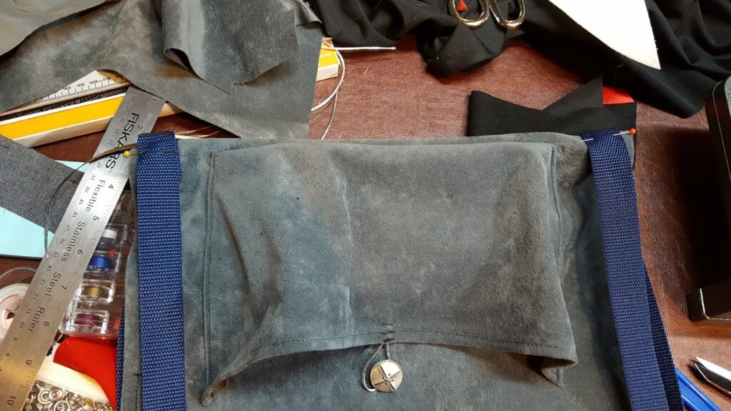 Fold carrier in half and pin nylon centers at this mark on each side. 