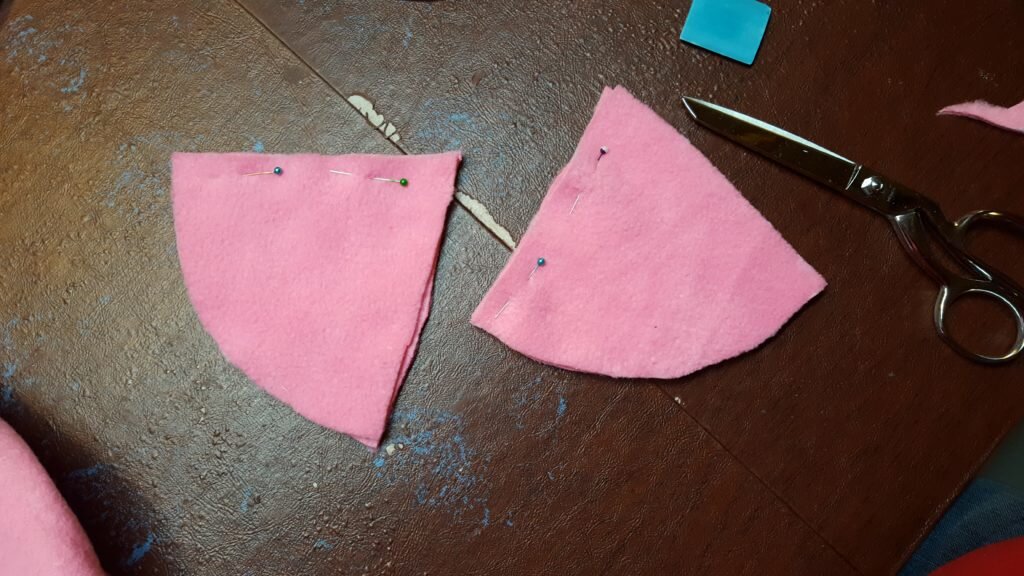 Pin two triangles together on one side. 