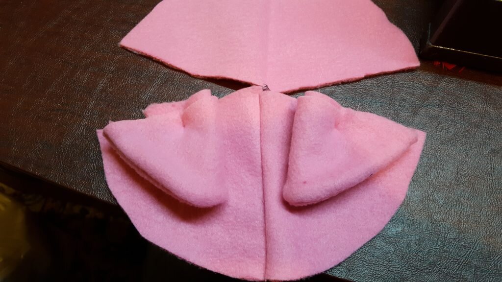 Turn ears into hat. 