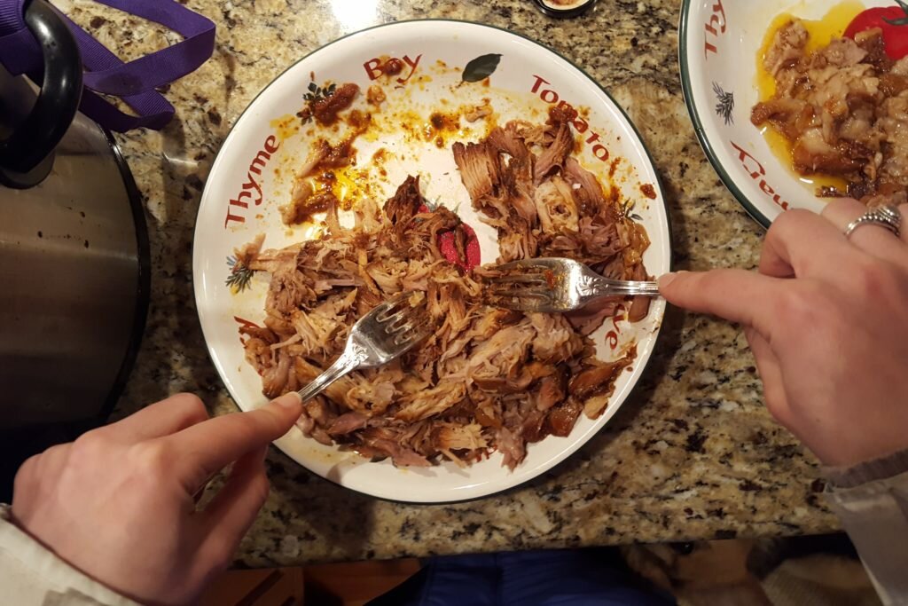 Remove fat then shred pork with forks. 